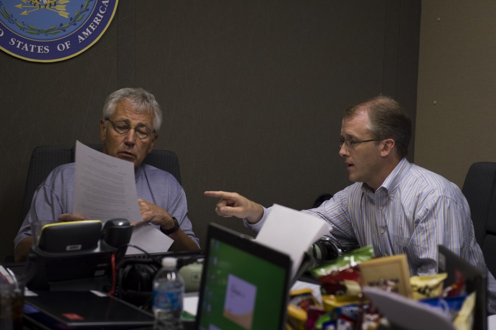 Defense Secretary Chuck Hagel talks with George Little before hosting a press briefing aboard the E-4B on his way to Malaysia. (DoD photo by Sgt. Aaron Hostutler)