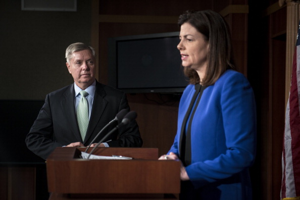 Sen. Lindsey Graham listens while Sen. Kelly Ayotte speaks during a press conference on Capitol Hill. (AFP PHOTO/Brendan SMIALOWSKI/Getty Images)