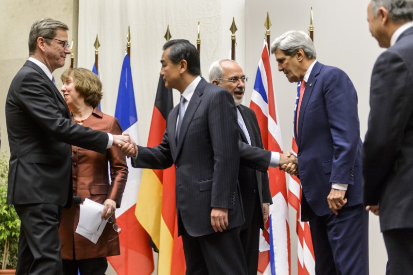 Iranian Foreign Minister Mohammad Javad Zarif, US Secretary of State John Kerry shake hands after a statement on Nov. 24 in Geneva. World powers reached an agreement with Iran over its nuclear program.  (FABRICE COFFRINI/AFP/Getty Images) 