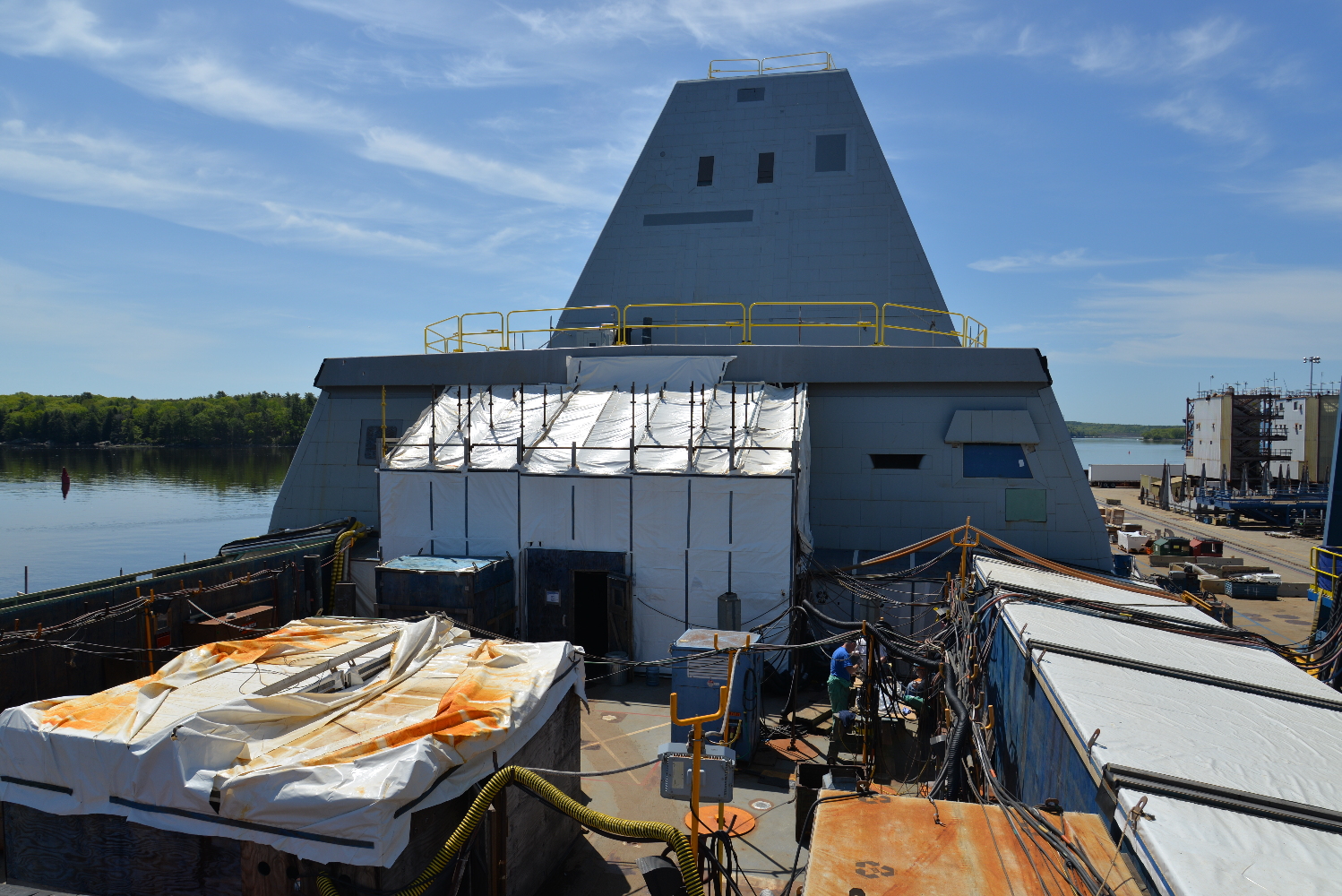 Seen from above the ship's flight deck, this view looks forward. The white construction  shed at left covers the hangar doors, while the large window at right is the ship's flight control center. Two Mark 46 30mm guns will be installed on top of the after deckhouse. 