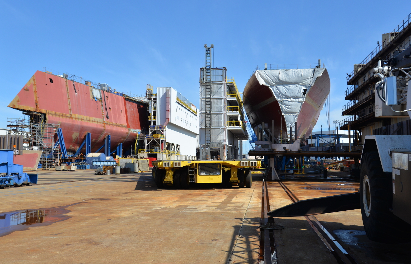 At left, the hull of the second ship in the class, the Michael Monsoor (DDG 1001), is coming together. At right is the Rafael Peralta (DDG 115), first of the latest batch of Arleigh Burke DDG 51-class destroyers under construction at Bath. Similar ships are built in Mississippi at Ingalls Shipbuilding. 
