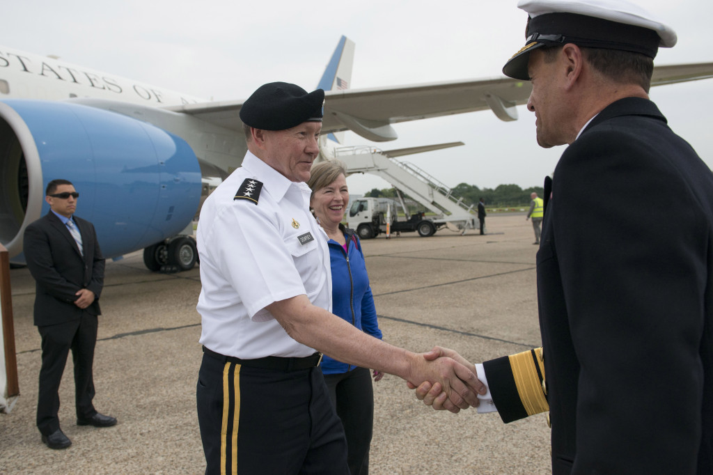 Gen. Martin Dempsey, chairman of the Joint Chiefs of Staff, and his wife, Deanie, exchange greetings with British Navy Rear Adm. Mackay as they arrive on Stansted Airfield, England, June 9. (DoD photo by US Navy Petty Officer 1st Class Daniel Hinton)